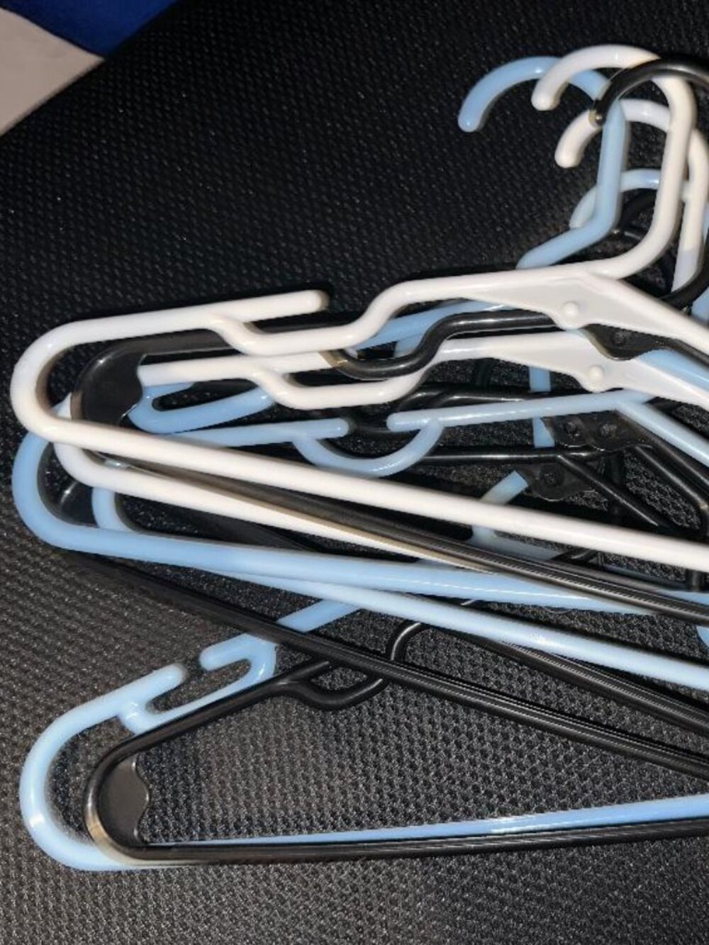 Set of 10 plastic kids/toddler clothes hangers in assorted colors.